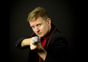 Michael Schiefel pointing a microphone towards the camera